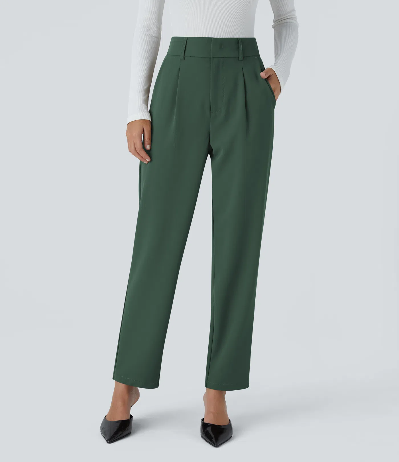 A model wearing green pleated pants
