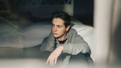 A lonely-looking young man.