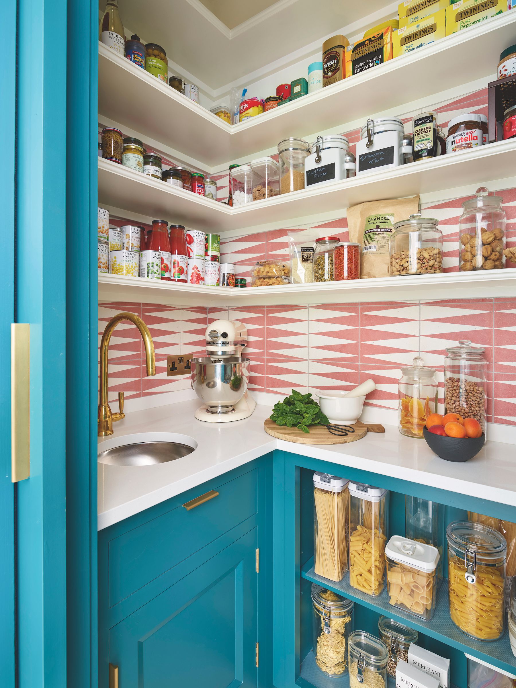blue pantry cupboard with pink and white backsplash tiles