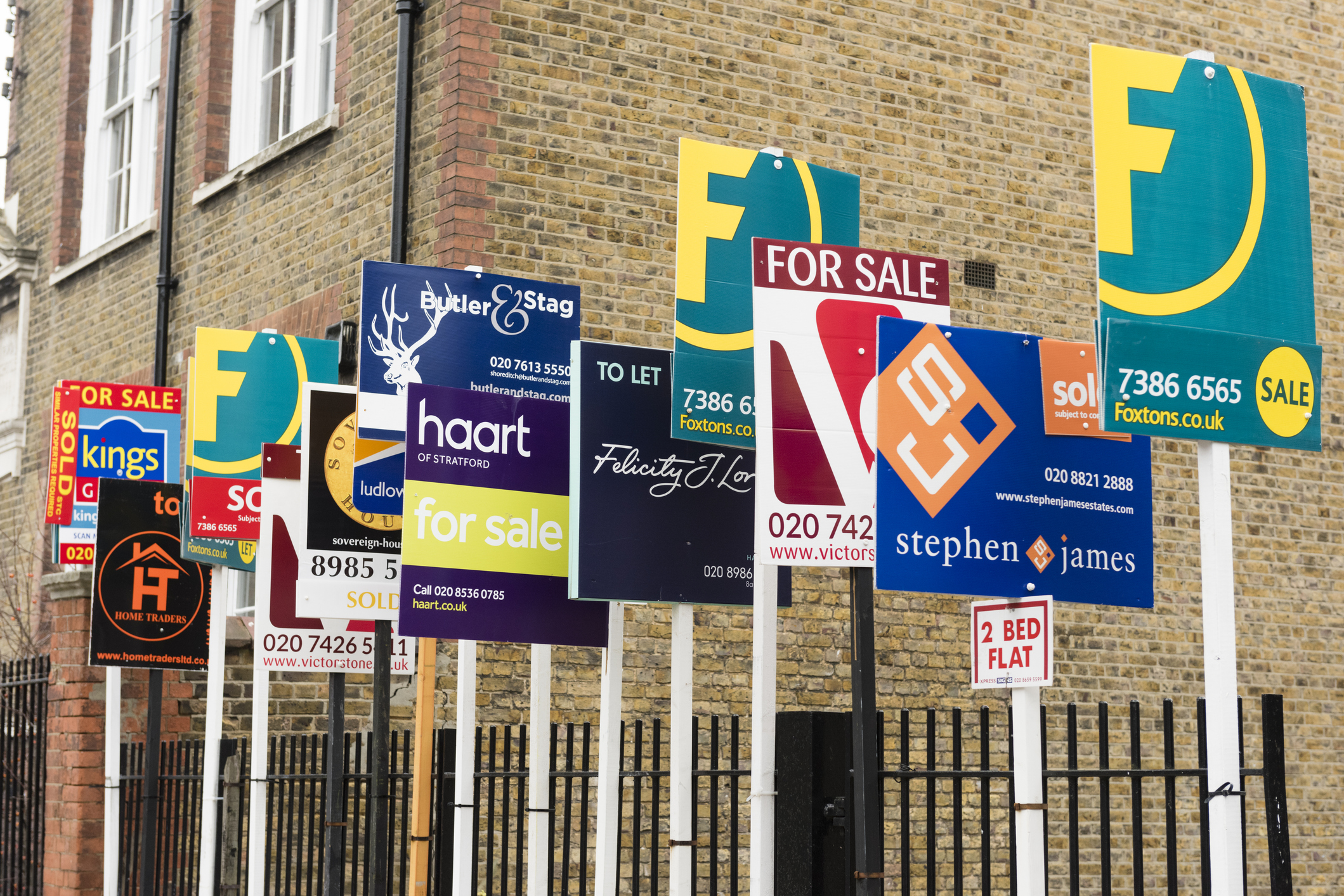 House for sale signs in front of property