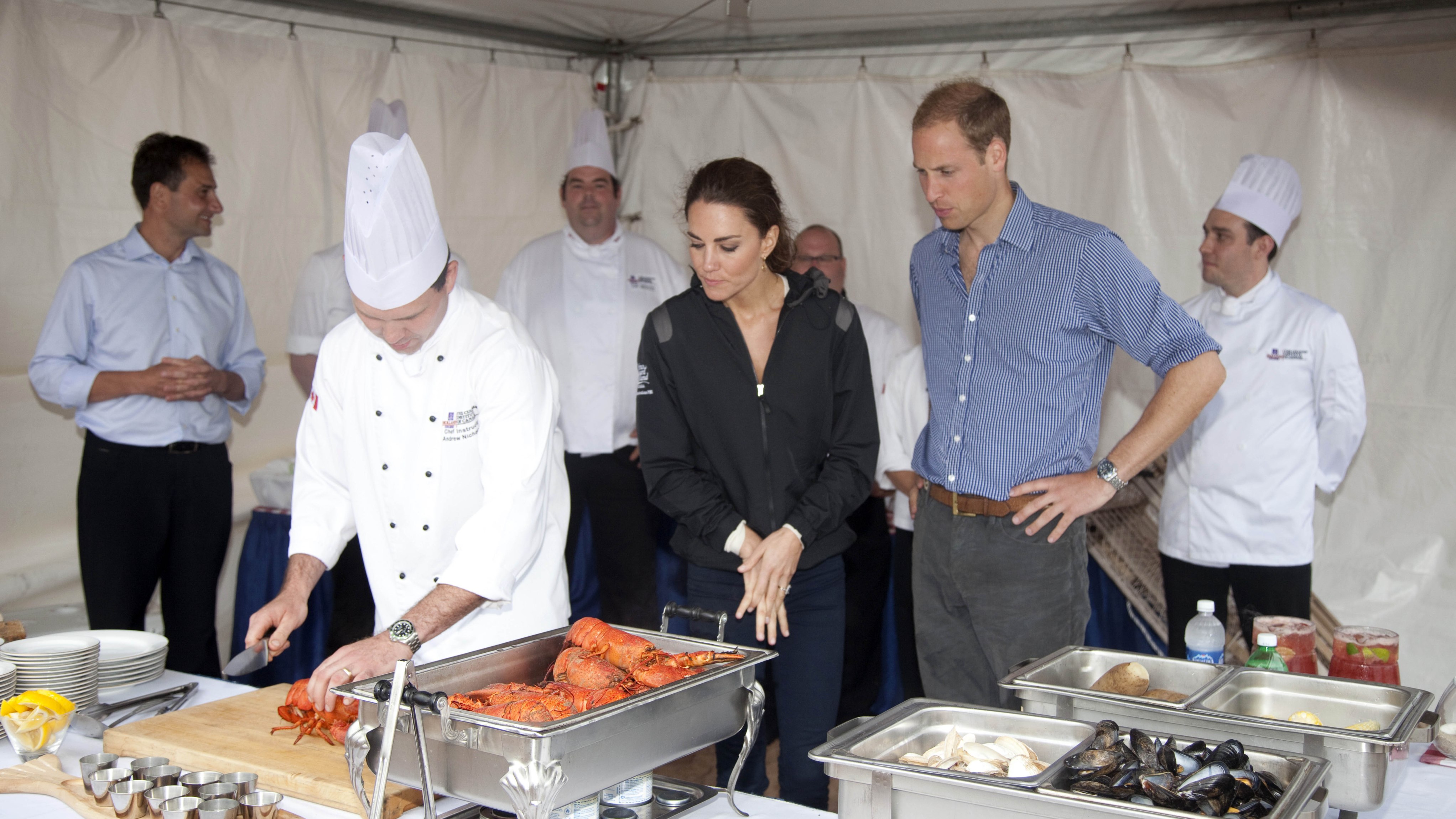 The Prince and Princess of Wales watch chefs prepare shellfish in 2011