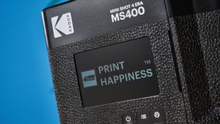 A black Kodak Mini Shot 4 Era 2-in-1 instant camera and printer