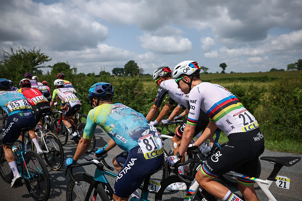 XDS Astana Team's Colombian rider Sergio Andres Higuita Garcia (C) and UAE Team Emirates XRG's Slovenian rider Tadej PogaÄar (R) cycle with the pack of riders during the 1st stage of the 77th edition of the Criterium du Dauphine cycling race, 195,8 km between DomÃ©rat and Montlucon, on June 8, 2025. (Photo by Anne-Christine POUJOULAT / AFP)