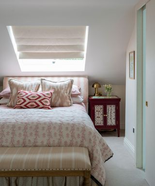 Attic bedroom, white painted walls, bed with pink patterned bedding