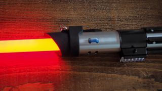 A closeup look at the Darth Vader Force FX Elite Lightsaber on a wooden table