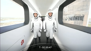 Ax-1 astronauts Mark Connor and Michael Lopez Alegria walking toward their Dragon capsule.