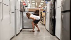 A woman shopping for refrigerators