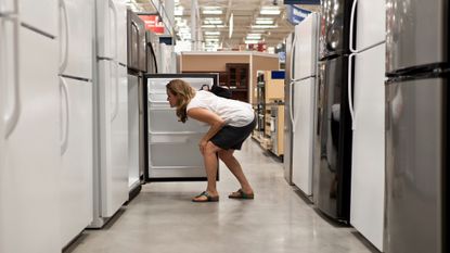 A woman shopping for refrigerators