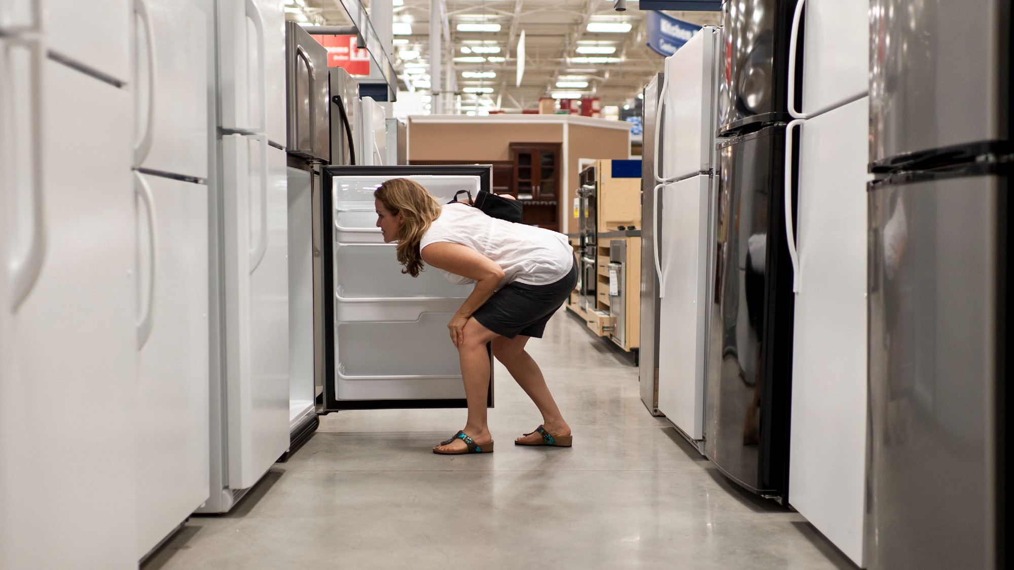 A woman shopping for refrigerators 