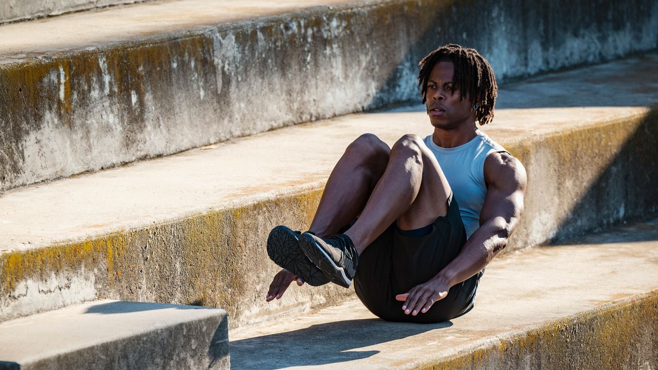 Man performing crunches outdoors