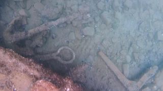 Among the artifacts discovered with the 19th-century shipwrecks: a small anchor, a chain plate, and an iron knee that was likely part of the ship's frame.
