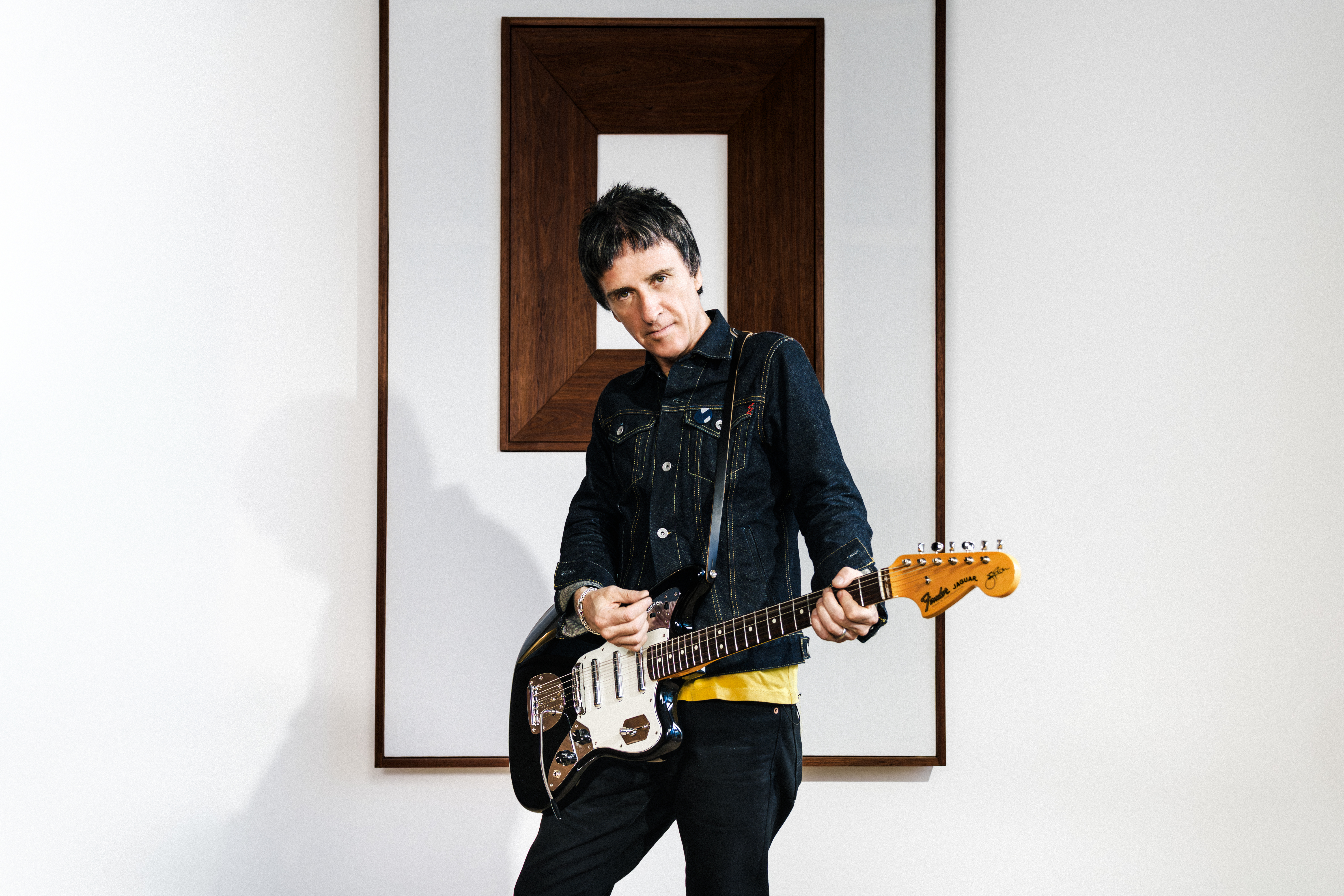 Johnny Marr posing with his second signature guitar with Fender