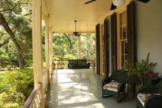 American front porch with shuttered windows and bench seating