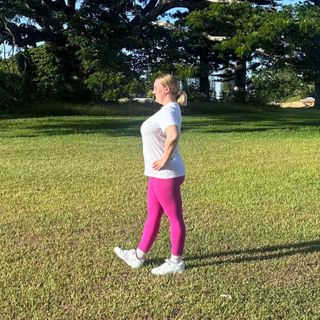 Woman demonstrating dynamic hamstring stretch