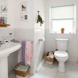 bathroom with white wall and towels