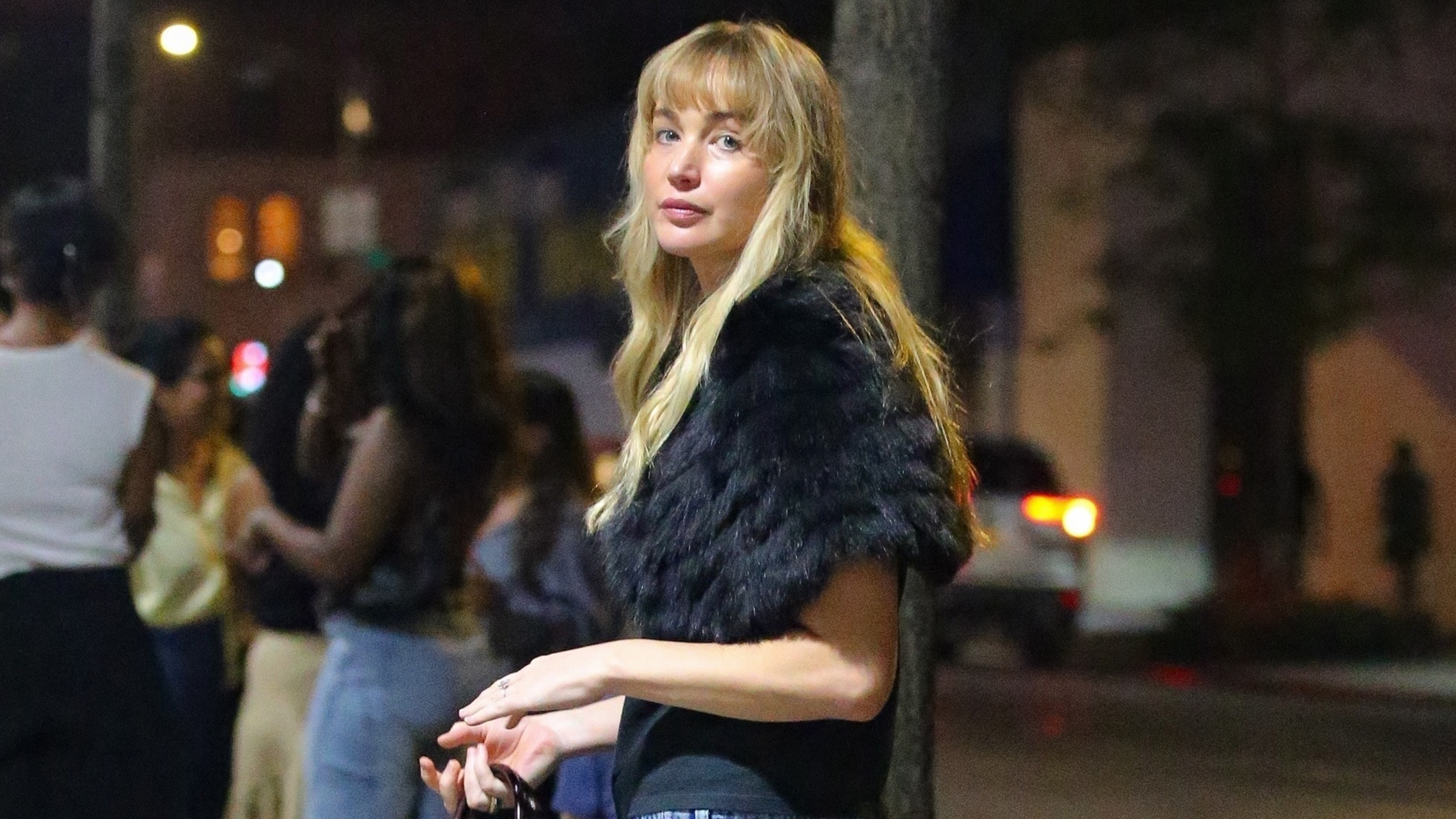 Jennifer Lawrence is spotted out and about in New York, wearing a black t-shirt and jeans and accessorizing it with black fur and a red leather bag.