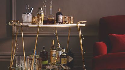 Home bar with red velvet armchair