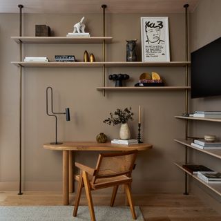 Office space with taupe walls and bookshelves
