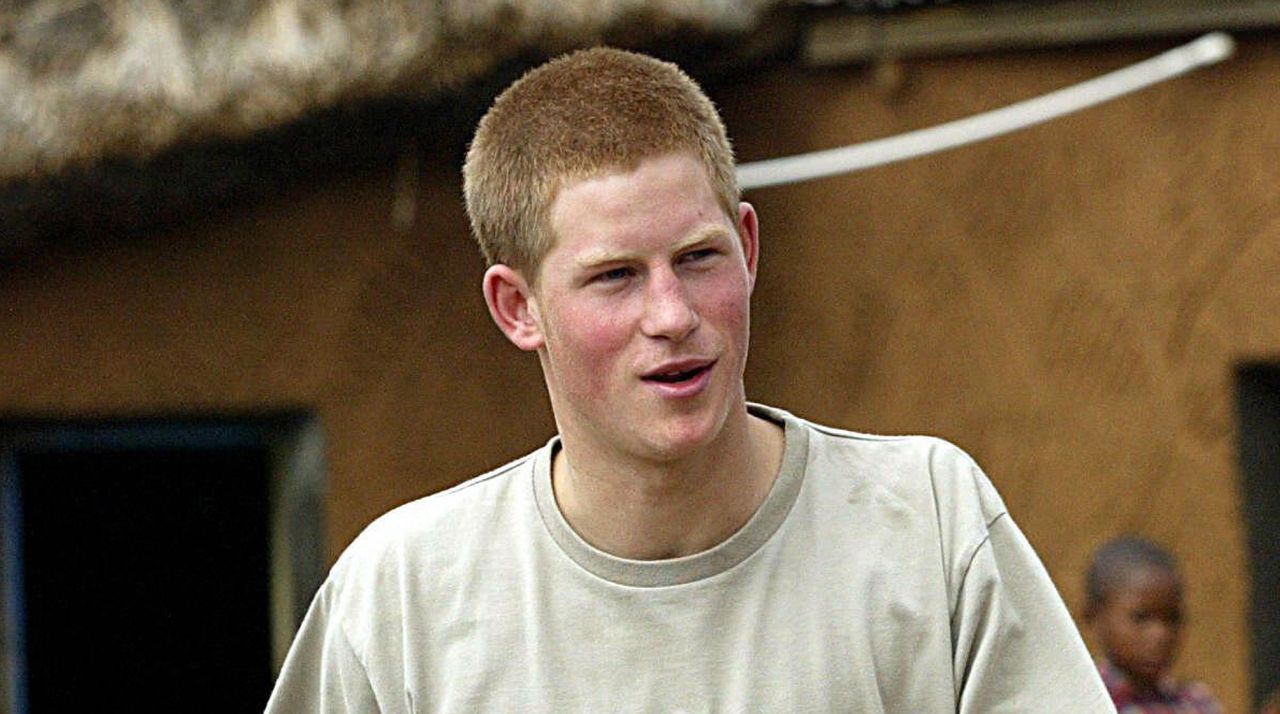 Prince Harry has very short red hair and is wearing an ecru T-shirt during his gap year in 2004 in Mohale&#039;s Hoek in Lesotho