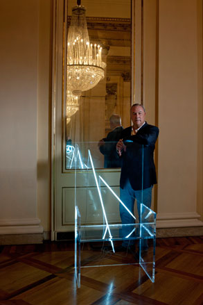 Rober Wilson standing in front of a large electric chair