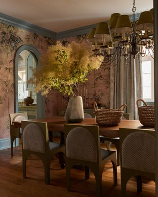 Dining room with pink botanical wallpaper and pastel blue trim
