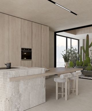 split level kitchen island featuring main island in small mosaic tiled effect then long slab of pale wood jutting out acting as dining area