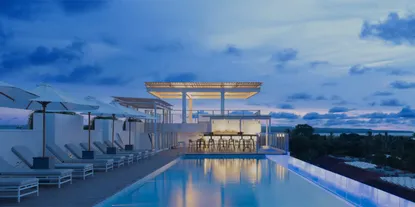 A beautiful IHG hotel with pool at sunset