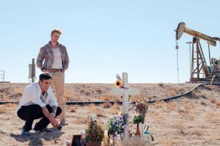 (L to R) B. J. NOVAK and BOYD HOLBROOK, at a grave in the desert, in VENGEANCE