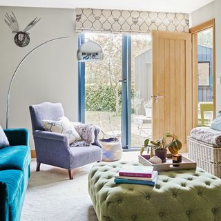 sitting room with sliding doors, green footstool and grey armchair