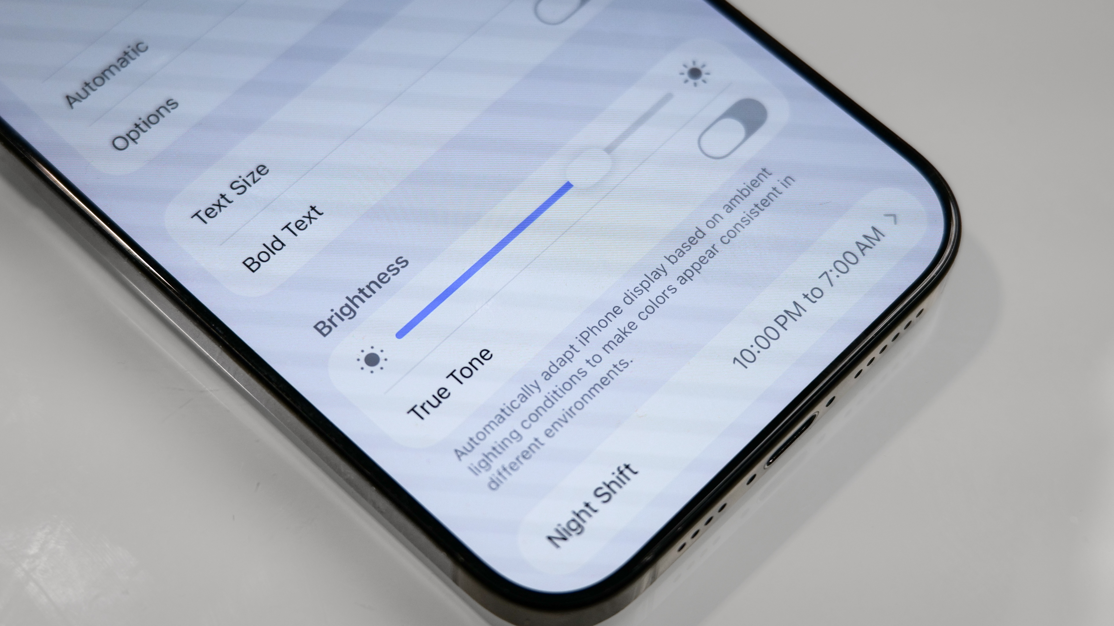 iPhone showing Auto-Brightness setting.