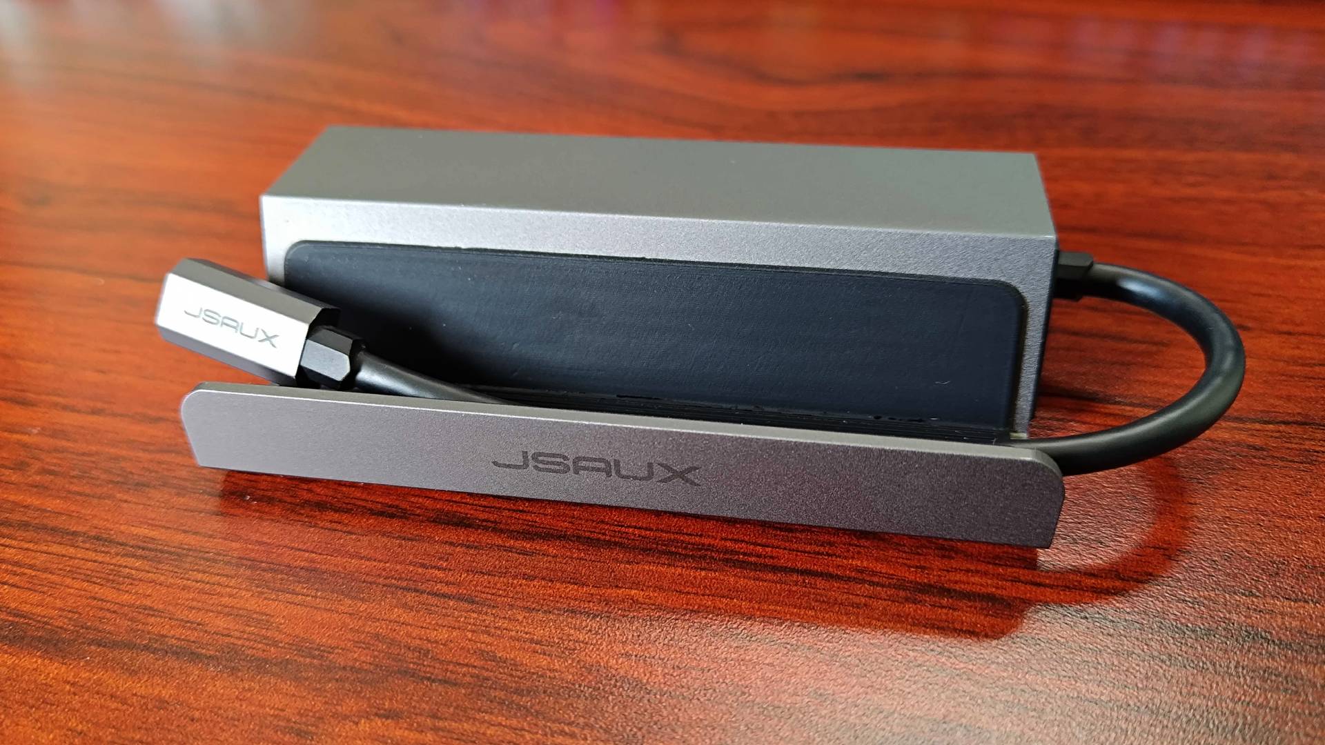 Front Jsaux 5-in-1- Steam Deck dock with logo and USB-C cable in view.