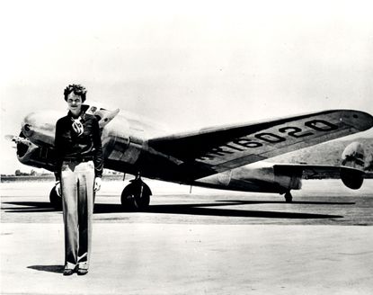 Amelia Earhart standing in front of the Lockheed Electra in which she disappeared in July 1937