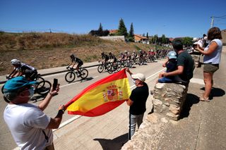 MOLINA DE ARAGON SPAIN AUGUST 17 A general view of Fabio Aru of Italy and Team Qhubeka Nexthash Thymen Arensman of Netherlands Michael Storer of Australia and Team DSM and the peloton while fans cheer during the 76th Tour of Spain 2021 Stage 4 a 1639km stage from El Burgo de Osma to Molina de Aragn 1134m lavuelta LaVuelta21 on August 17 2021 in Molina de Aragn Spain Photo by Gonzalo Arroyo MorenoGetty Images