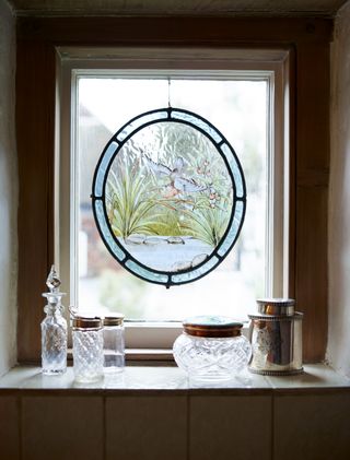 stained glass window with decorative jars