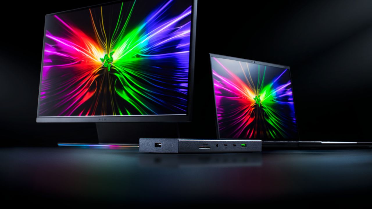 The Razer USB4 Dock in front of a Razer monitor and laptop with a black background.