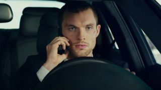 Ed Skrein taking a serious call while driving in The Transporter Refueled.