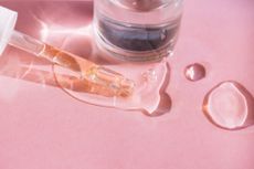 product shot of medicine dropper with glycerin on a pink background