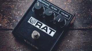 A Pro Co Rat 2 distortion pedal on a wooden floor