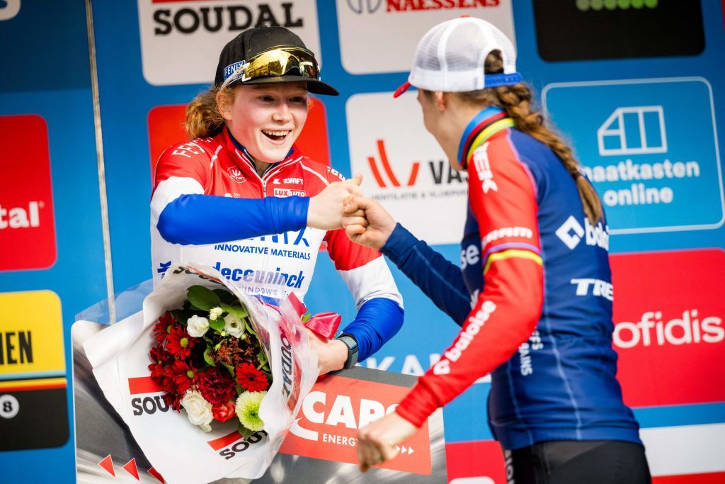 Dutch rider Puck Pieterse L and Dutch rider Lucinda Brand R fist pump on the podium after the womens elite race at the Urban Cross Kortrijk cyclocross cycling event the second stage in the X2O Badkamers Trofee Veldrijden competition in Kortrijk on November 25 2023 Photo by JASPER JACOBS Belga AFP Belgium OUT Photo by JASPER JACOBSBelgaAFP via Getty Images