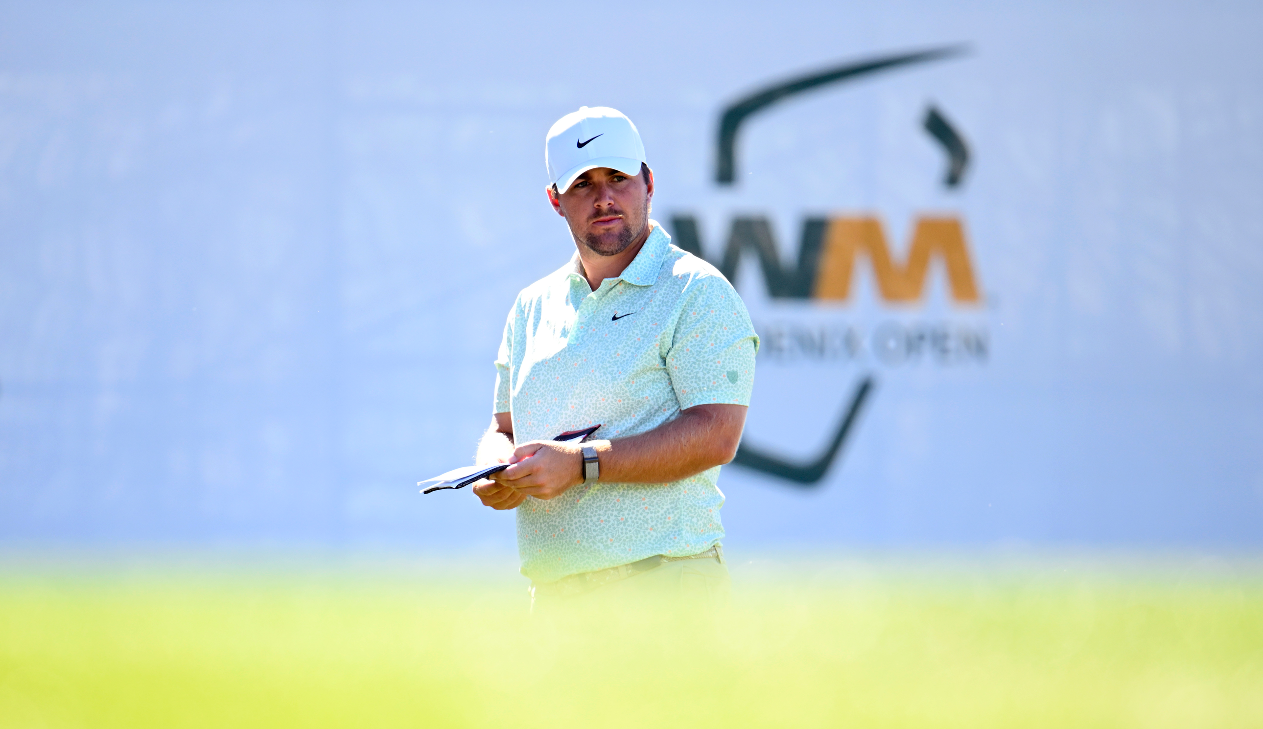 Chris Gotterup looks at his yardage book