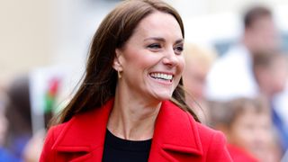 Kate Middleton smiling in red coat