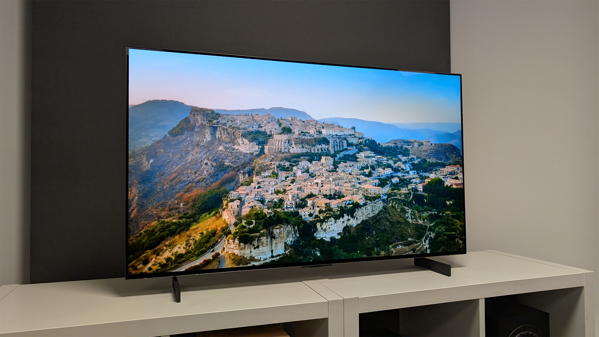 LG C5 42-inch OLED TV with aerial view of hillside town on screen