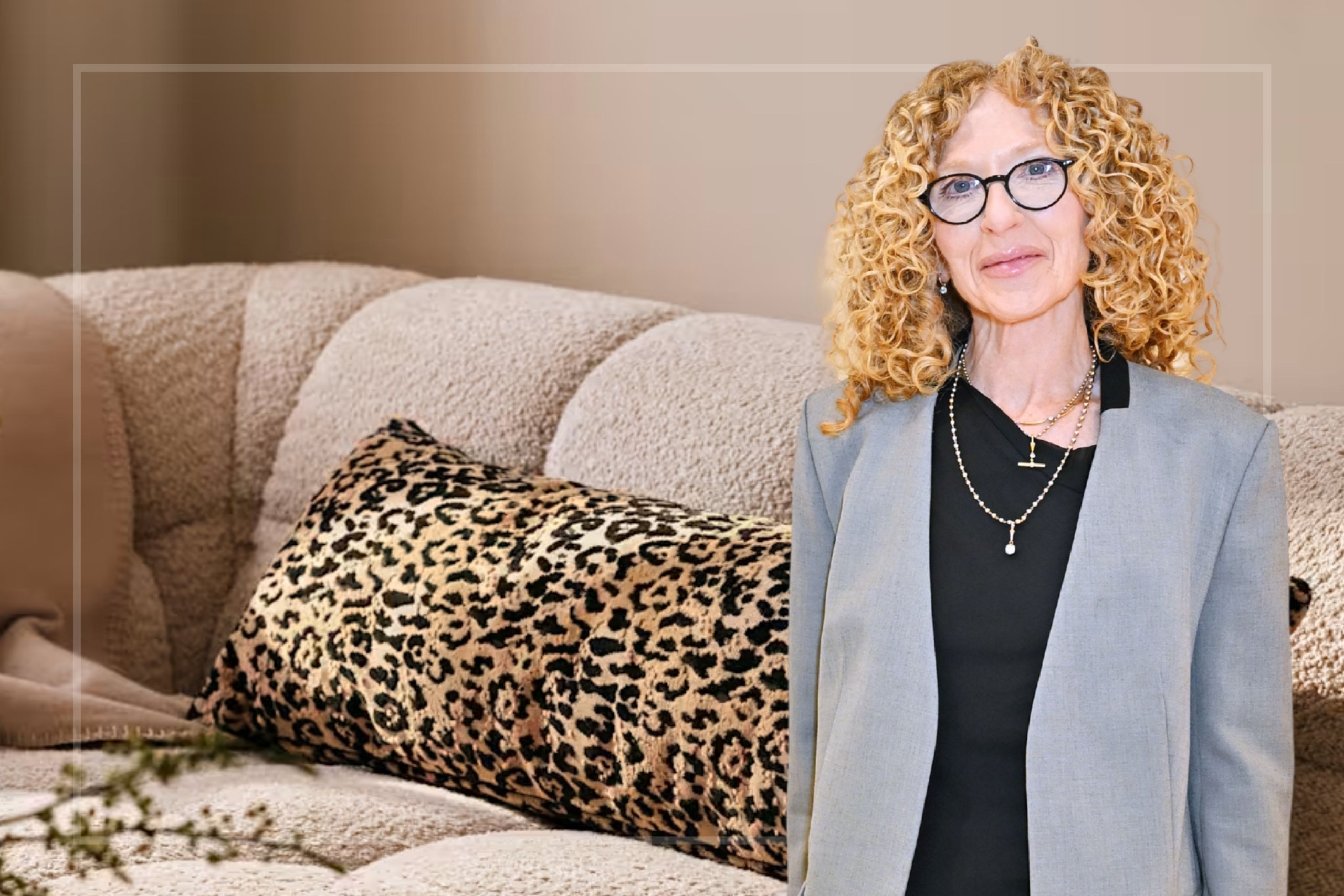 A comp image of the M&amp;S X Kelly Hoppen leopard cushion on a sofa with an insert of Kelly Hoppen (R)