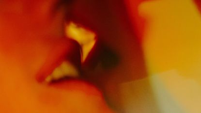 Pheromone perfumes: close up of two mouths kissing