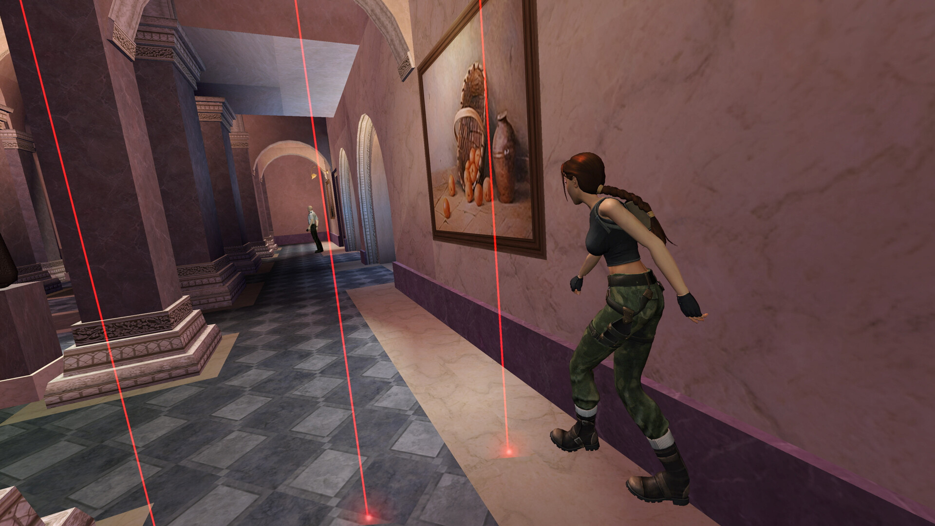 A screenshot from Tomb Raider 4-6 Remastered showing Lara Croft sneaking past lasers