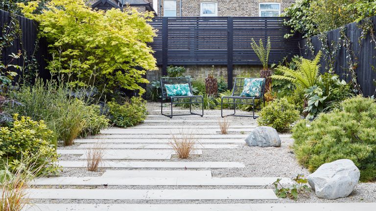 Modern rock garden ideas with stone path and gravel with bolders and a seating area