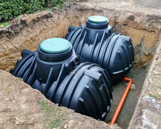Two plastic underground storage tanks placed below ground for harvesting rainwater