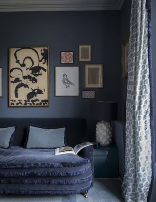 A living room layered with navy blue tones