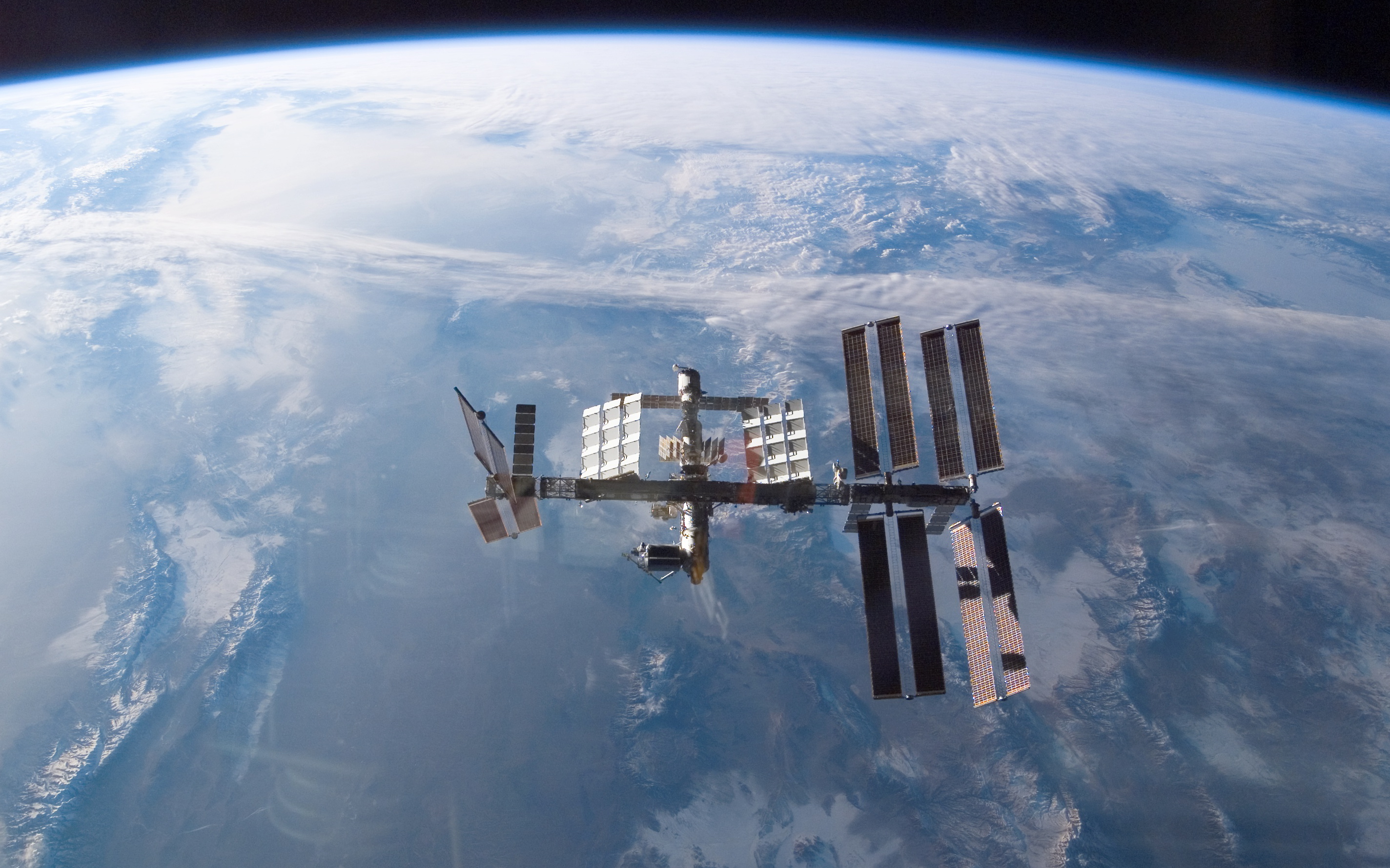 An external view of the International Space Station above Earth.