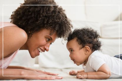 When do babies smile illustrated by woman and baby on tummie smling